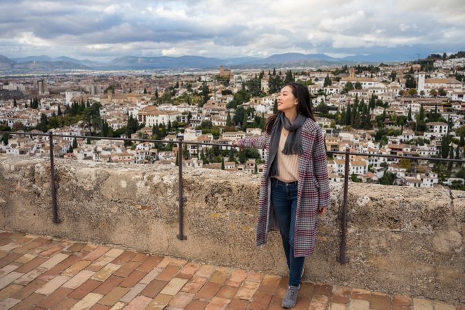 Cheerful woman visiting ancient city