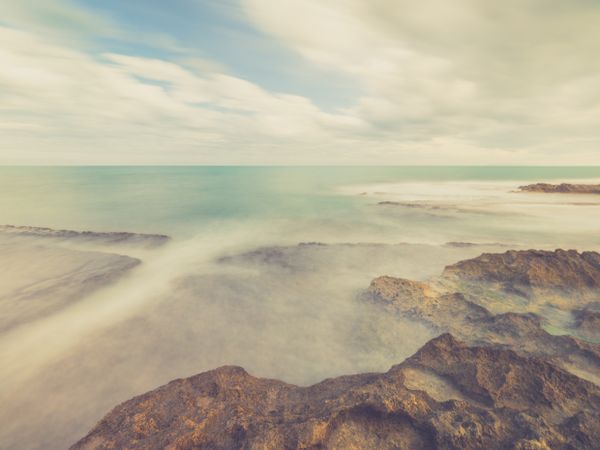 Rocky seashore under blue sky