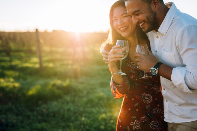 Loving couple enjoying a glass of wine at a vineyard