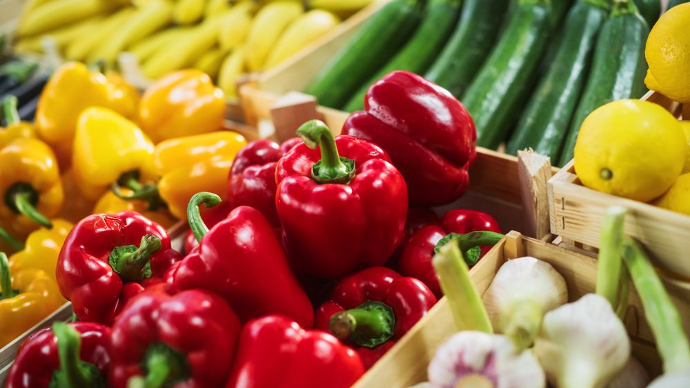 Close Up Shot with a Selection of Fruits and Vegetables Being Sold on a Food Stand at a Farmers Market.