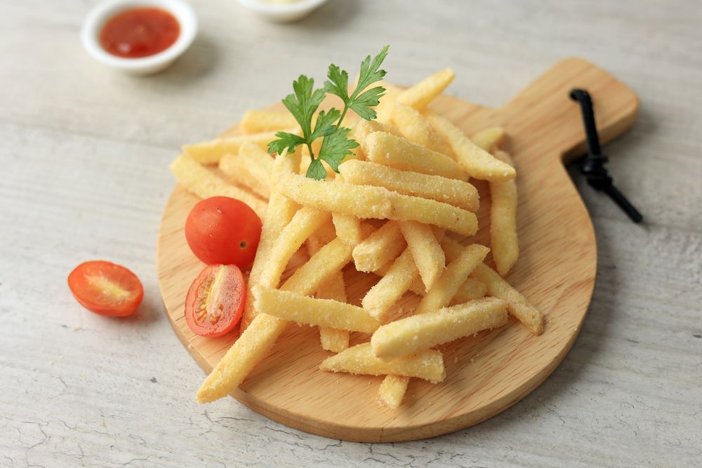 French Fries Served on Wooden Board Coating with Spice and Salt.