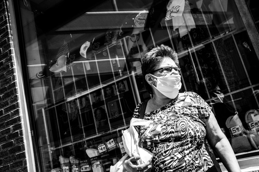 MONTREAL, QUEBEC, CANADA – May 29 2020- Woman is wearing a mask in the street