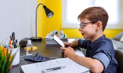 Teenager doing homework with a tablet