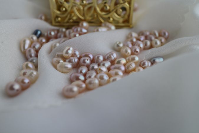Close up of freshwater cultured pearls on soft satin silk