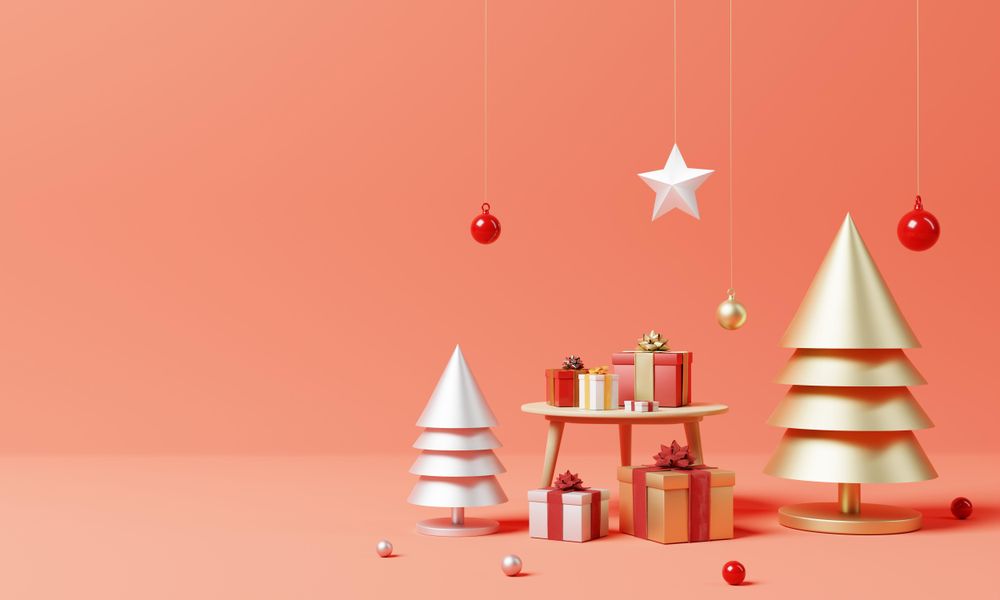 Wrapped red present with ornamental tree and star, copy space