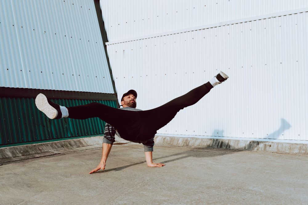 Trendy male flipping on street