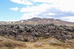 Leirhnjúkur volcano showing solidified lava and patches of snow in iceland
