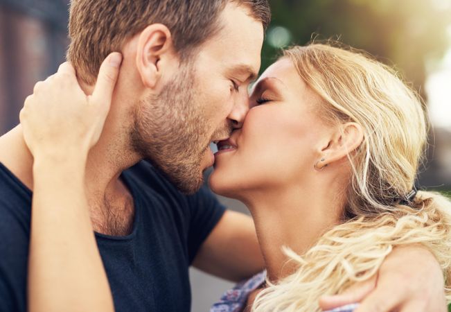 Close up of couple kissing passionately with eyes closed