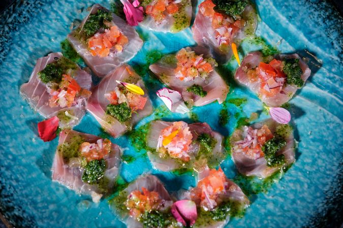 Plate with delicious fish dish on marble surface
