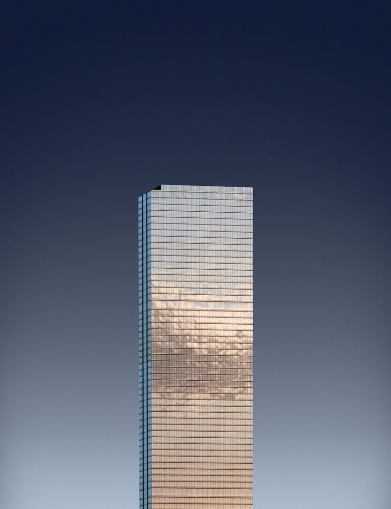 Reflective solo sky scrapper against a dark blue gradient sky