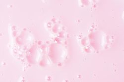 Soap bubbles on pink backdrop, minimal