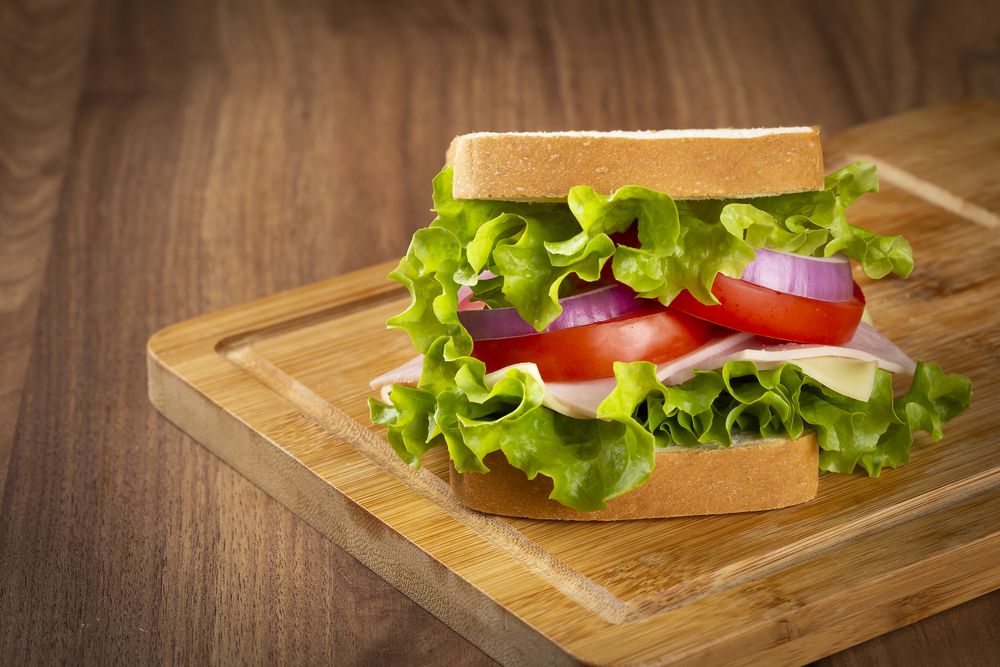 Natural sandwich. Sandwich with cheese, ham, lettuce, tomato and red onion.