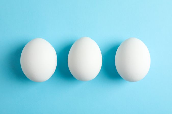 Chicken eggs on color background, space for text