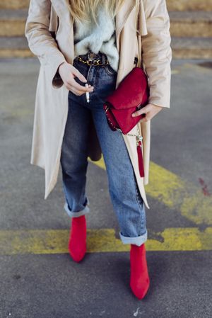 Young stylish woman standing on street road