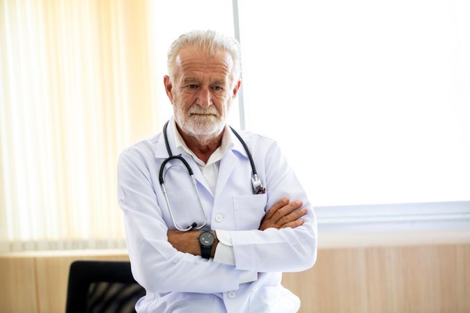 Portrait of mature doctor looking at camera in the hospital