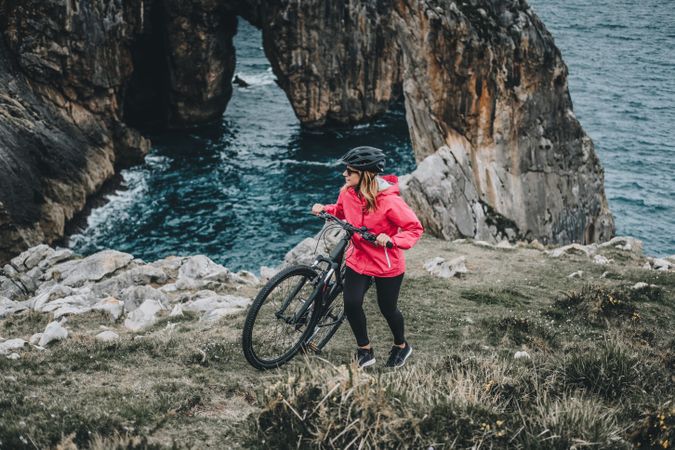 Female bicyclist on rocks