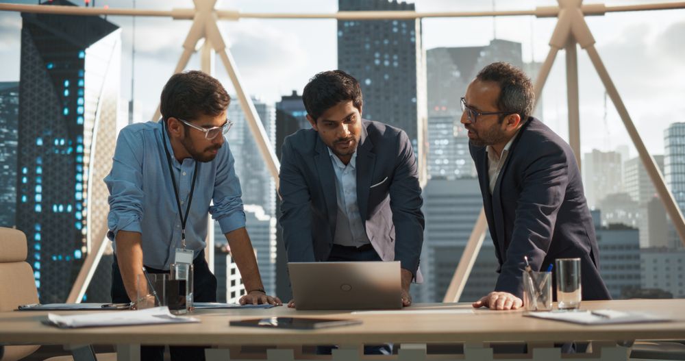 Cinematic Footage of a Successful Indian CEO Making a Presentation on a Laptop to a Board of Directors During a Corporate Meeting.