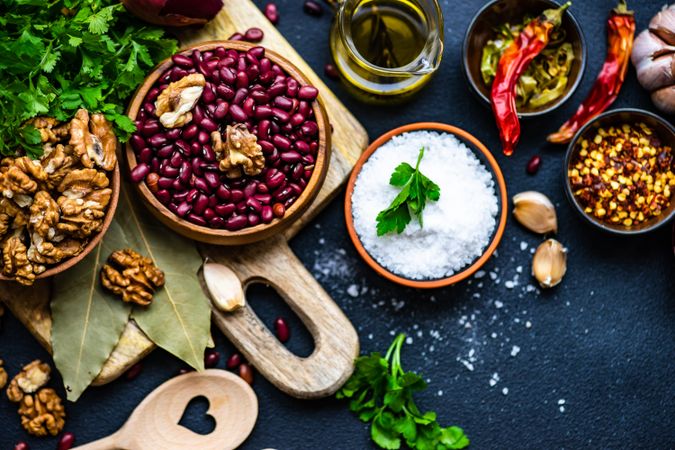 Dried kidney beans and bowls of other ingredients on kitchen counter