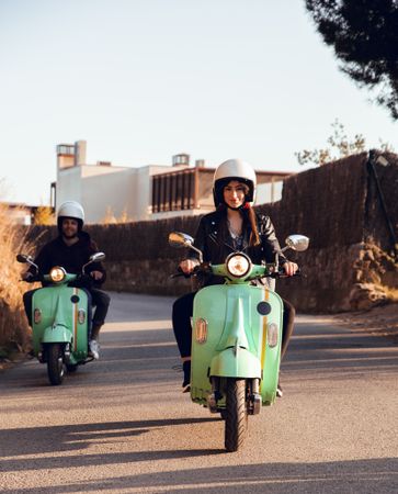 Young people riding motorcycles on city road