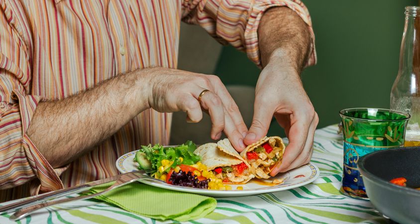 Man hands eating mexican food