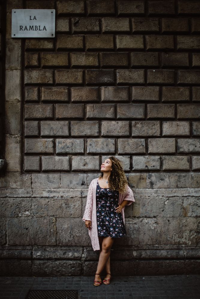 Adult woman leaning on old stone wall