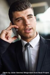 Portrait of man with blue eyes in suit and tie on phone 4Meak4