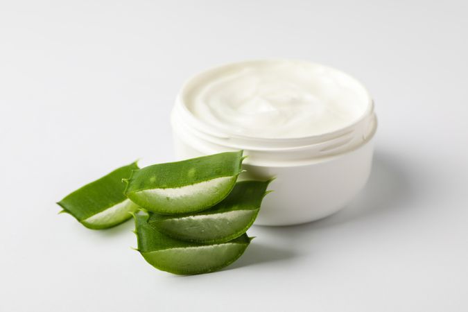 Composition with natural treatment accessories on plain background, space for text. Aloe vera