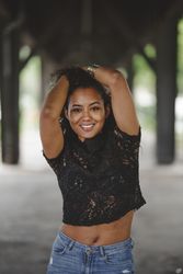 Cheerful hispanic model holding hair