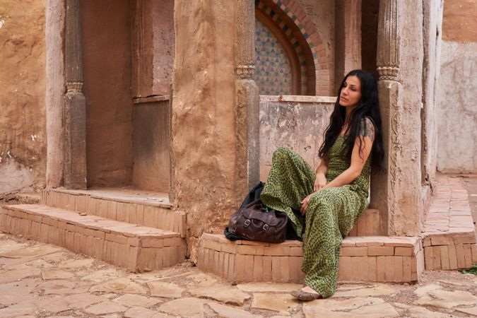 Woman on street between ancient buildings