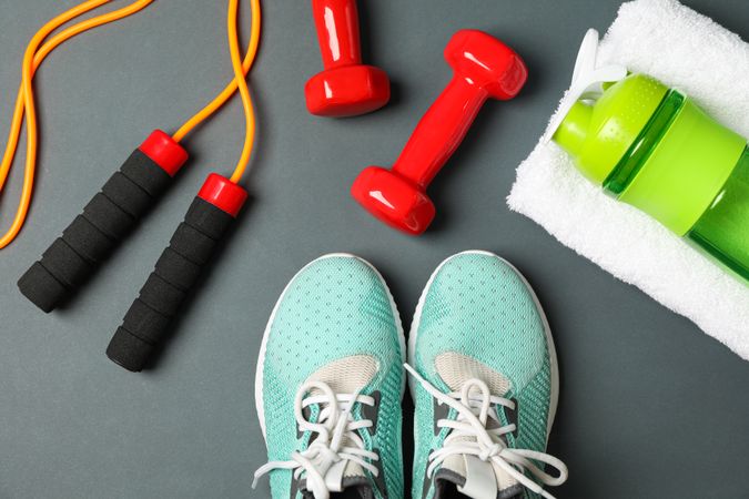 Flat lay composition with healthy lifestyle accessories on dark background