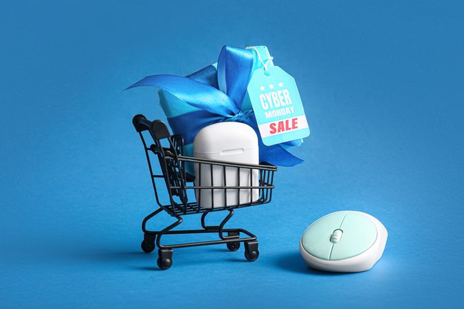 Wireless Earbuds Cyber Monday Sale Displayed with Mini Shopping Cart and Mouse
