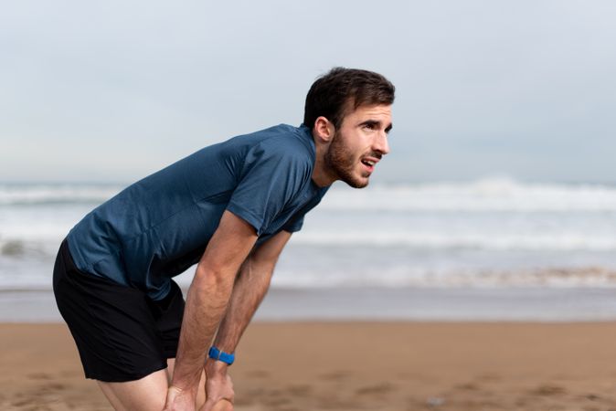 Sportsman resting on beach