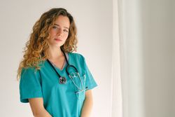 Emotionless female physician with stethoscope