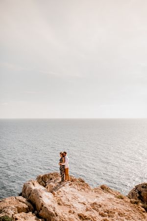 Couple embracing on rock