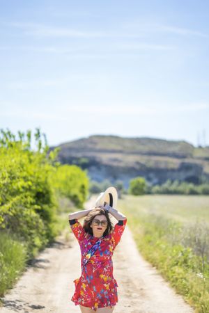 Woman walking along countryside road