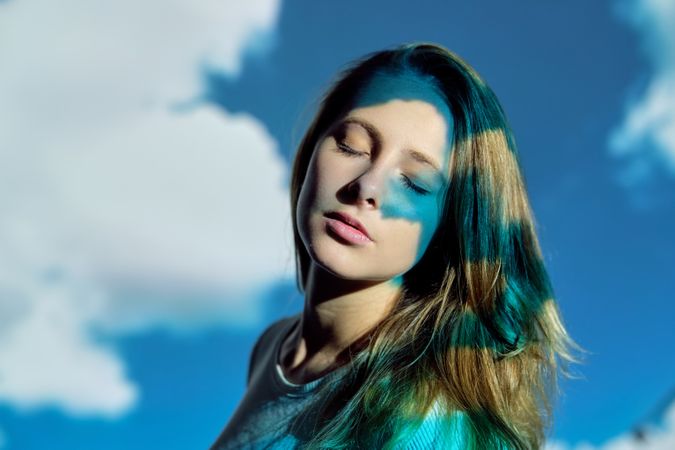 Calm woman against cloudy sky