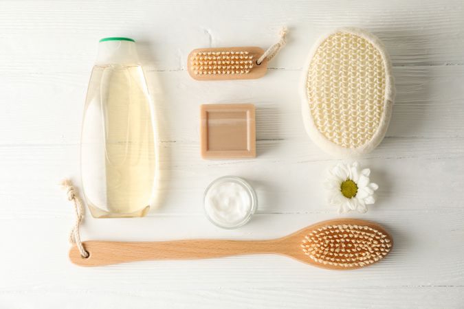 Flat lay composition with body care accessories on wooden background, space for text