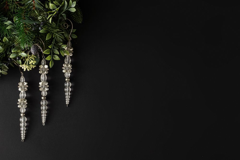 Festive icicles and leaves on dark background