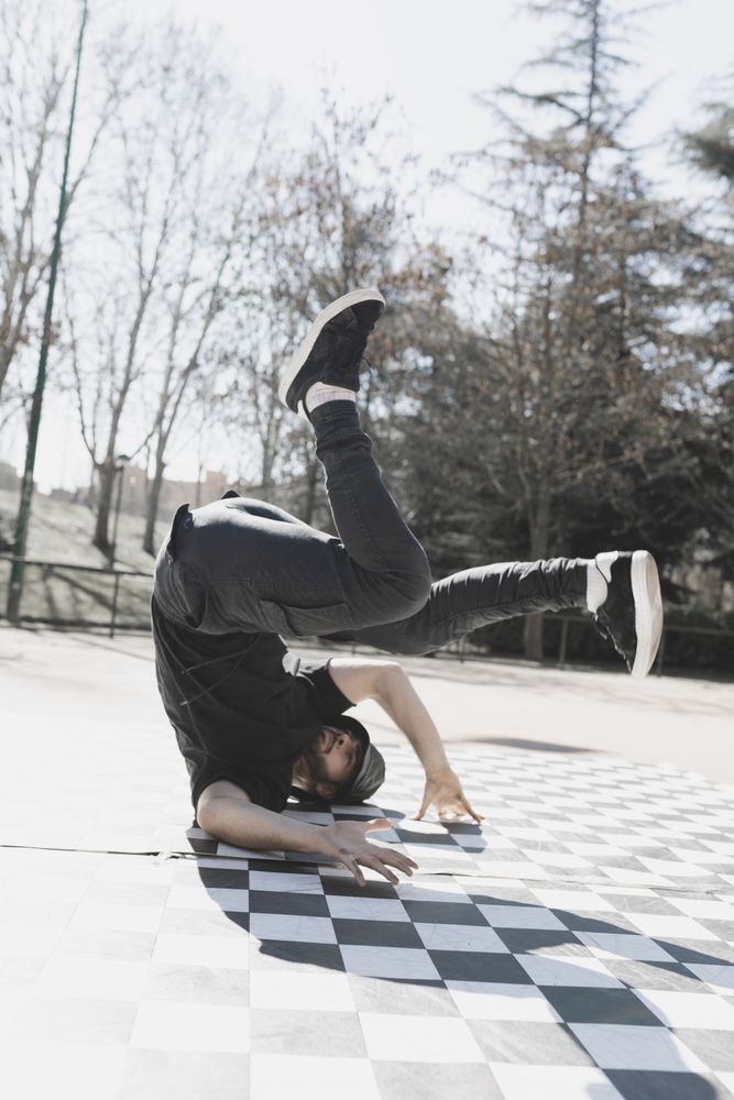 Man dancing break dance in park