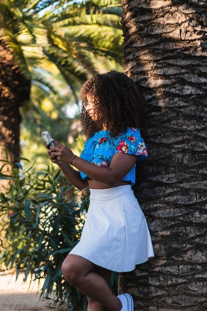 Stylish woman using smartphone on street