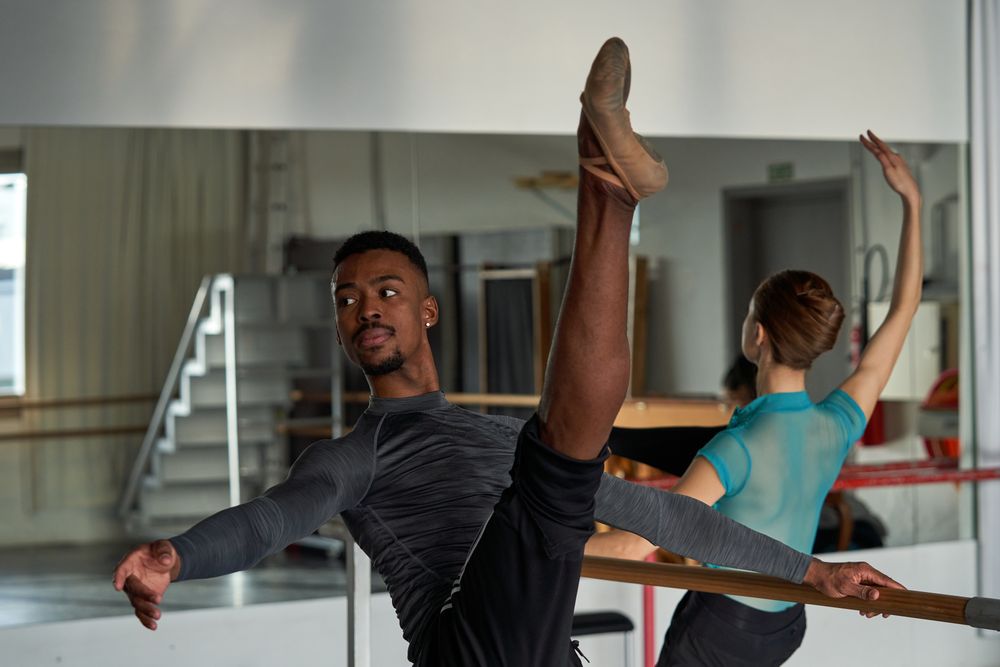 Couple of two dancers in a class doing a training in ballet academy