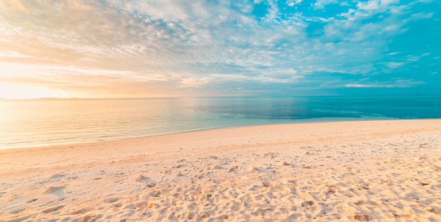 Beautiful sandy beach with idyllic blue waters, wide