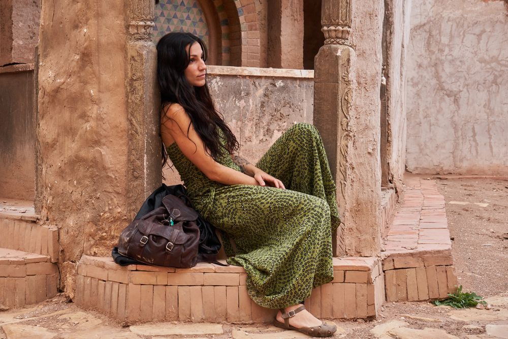 Woman on street between ancient buildings