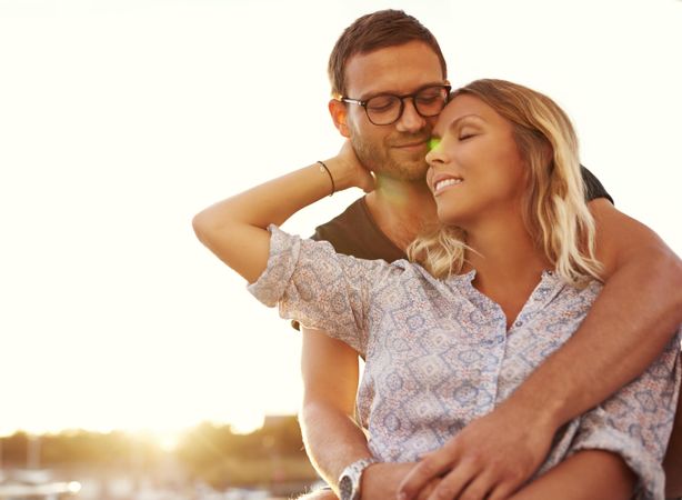 Couple lovingly embracing in the sunset