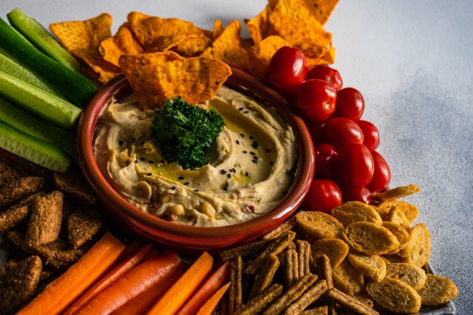 Traditional dish of hummus, fresh vegetables and chips