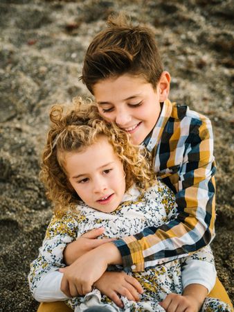 Cute boy and girl hugging each other at beach