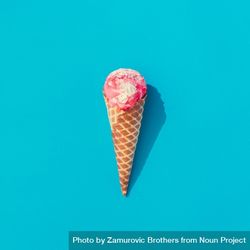 Waffle cone of pink ice cream on bright blue background 5aP7A0