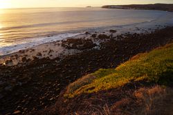sandy and rocky beach and the ocean in sunset lights in canary island