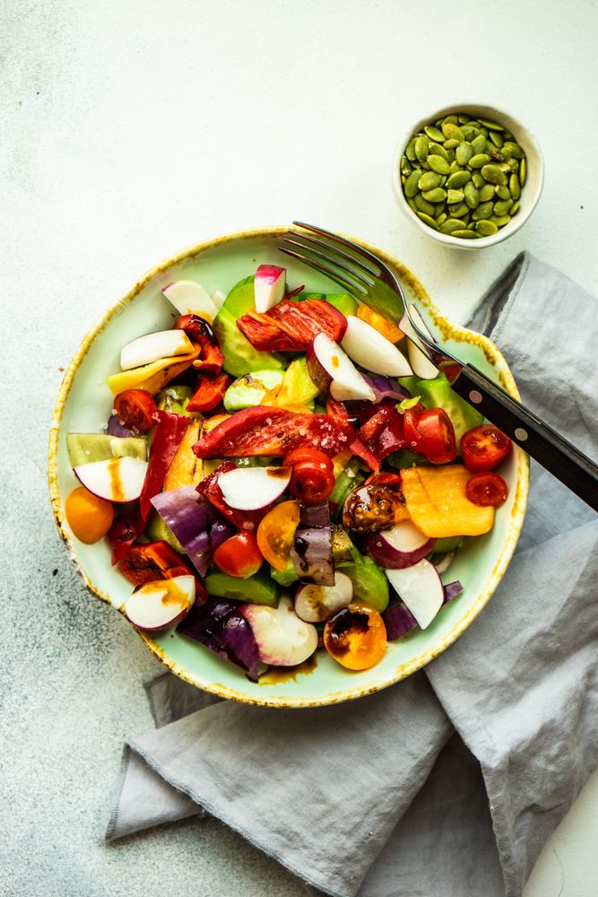 Top view of raw salad with freshly chopped vegetables