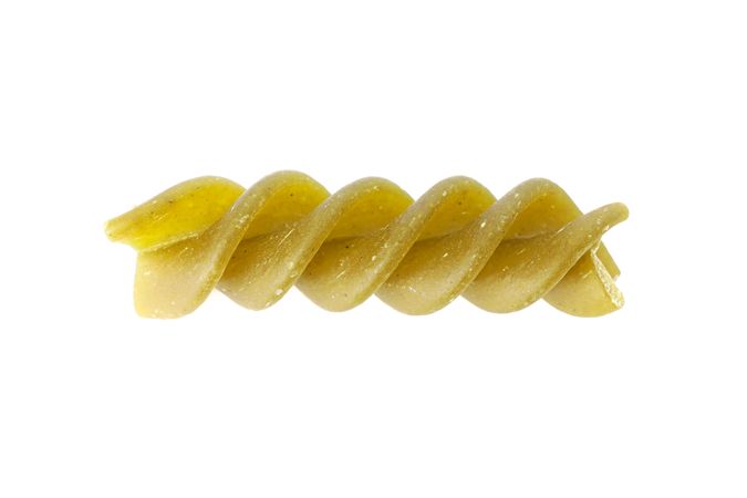 Pasta isolated on bright background, closeup. Dry raw whole pasta